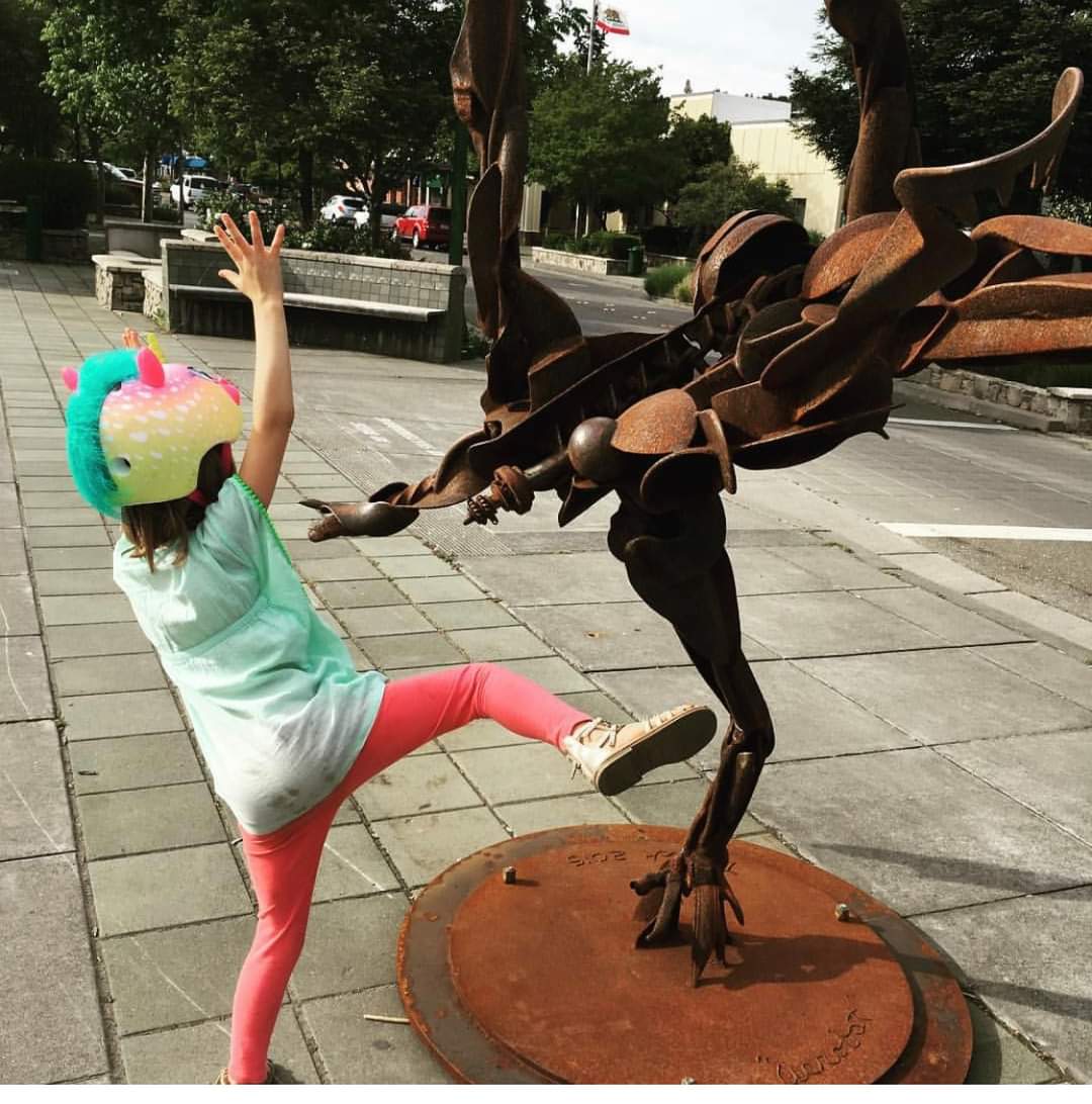 Young girl imitating sculpture pose